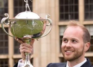 Michael Bradfield holding the PGA Assistant Trophy